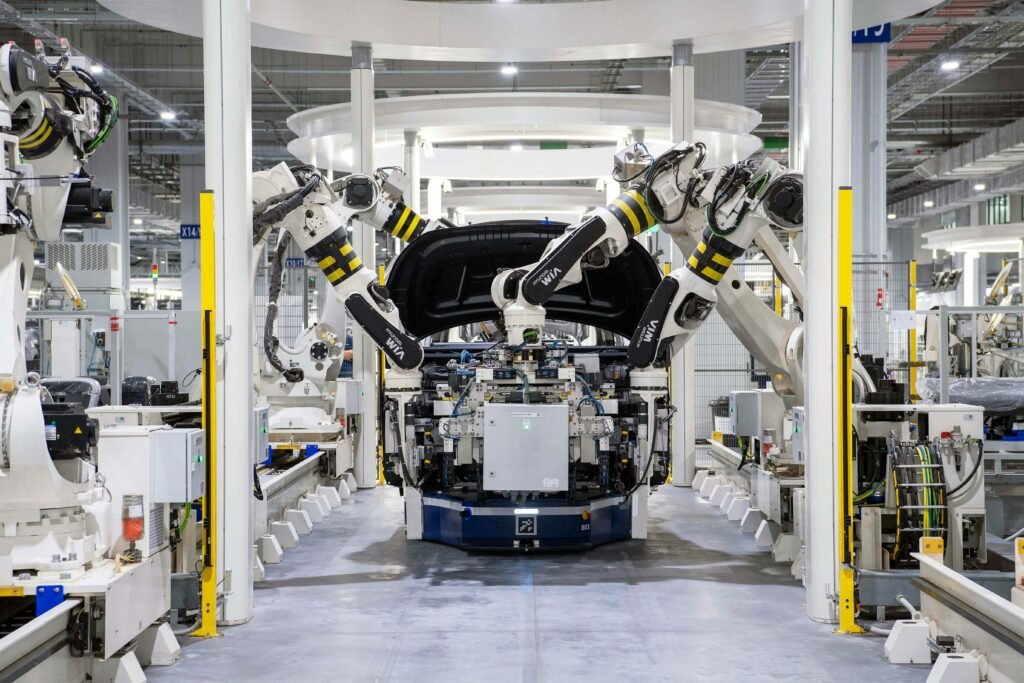 High-tech robots assembling a car in a modern factory setting, showcasing automation.